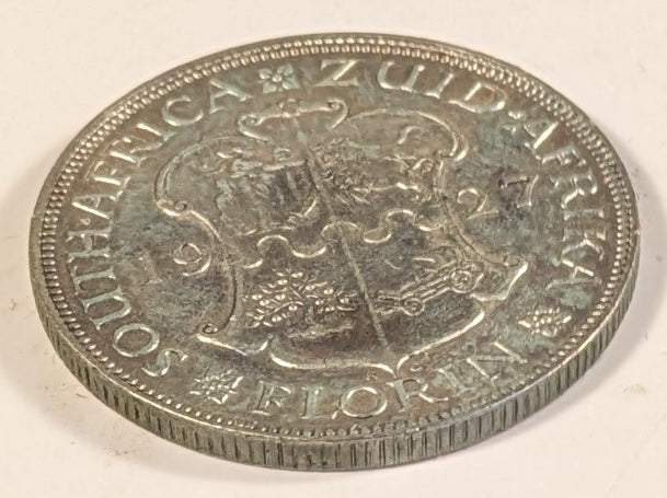 SOUTH AFRICA, Union of So. Africa, Dominion ~ 1927 ~ 1 Florin ~ Crowned bust of George V left ~ Arms divides date. Denomination as FLORIN. ~ Y-20, KM-18 ~ VF/EF