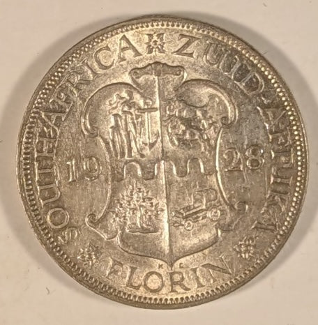 SOUTH AFRICA, Union of So. Africa, Dominion ~ 1928 ~ 1 Florin ~ Crowned bust of George V left ~ Arms divides date. Denomination as FLORIN. ~ Y-20, KM-18 ~ EF